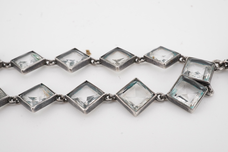 An Arts & Crafts white metal and paste cluster set circular pendant, diameter 33mm, hung from an associated white metal and quartz set necklace, 37cm.